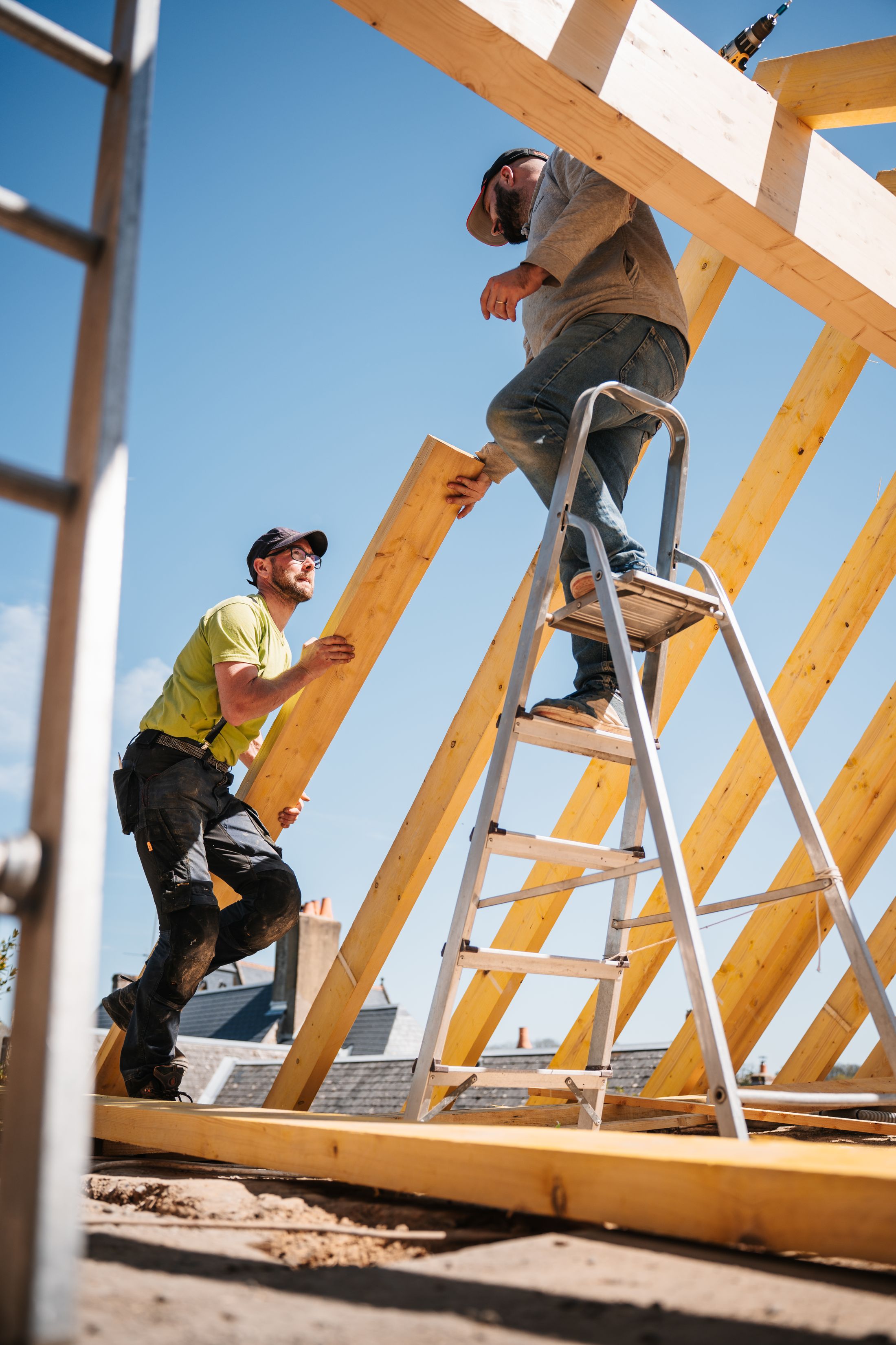 Roofer on a ladder working at the gutter line