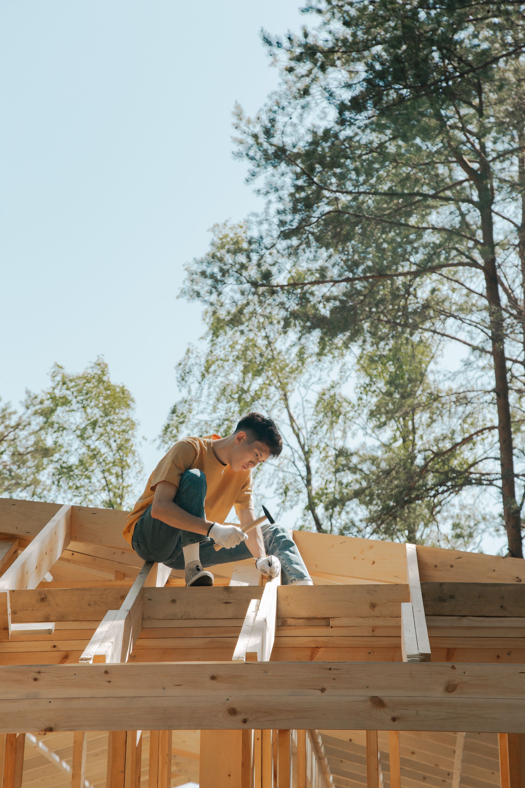Roofer fixing roof sheeting on a Queensland home